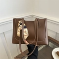 Brown tote bag with contrast stitching and floral scarf handle on a minimal background - Dark Brown