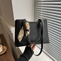 Classic black leather tote bag with white contrast stitching and floral silk scarf detail - Black