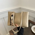 Chic beige leather tote bag with white stitching and stylish silk scarf on handle - Khaki