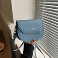 Light blue faux leather saddle bag with Fashion Trend print and silver metal hardware - Blue