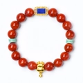 Red agate bracelet featuring a golden zodiac pig pendant and blue lapis lazuli inlay - Zodiac Ox