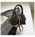 Elegant black shoulder bag with gold V buckle and metal tassel in a sleek leather finish - Black