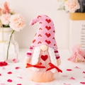 Pink knit Valentine's gnome plush with heart patterns and cute braided white pigtails - Pink Valentine Gnome Female Style