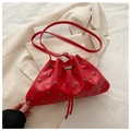 Red drawstring bucket bag with metal rivet studs and matching adjustable shoulder strap - Red