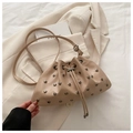 Chic cream drawstring bucket bag with silver stud accents and adjustable crossbody strap - Khaki