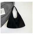 Black suede tote bag with laser-cut floral patterns and a minimalist chic design - Black