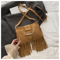 Detailed close-up of brown suede bag with long tassels and large metallic buckle - Brown