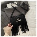 Detail of black tassel crossbody bag with vintage metal buckle on soft fabric - Black