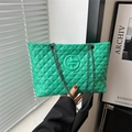 Large bright green quilted tote bag with chain strap and circular logo emblem - Green