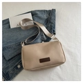 Detail of a beige canvas handbag with a leather patch and adjustable woven strap - Khaki