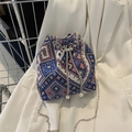 Ethnic geometric canvas bucket bag with silver chain strap and pearl drawstring detail - Blue