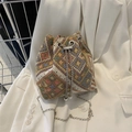Ethnic woven bucket bag with colorful geometric patterns and elegant pearl drawstring accents - Khaki