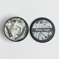 White Sage scented candle in black tin with white crystals and dried sage leaves - White Sage