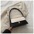 Elegante bolso de mano en cuero de contraste blanco y negro con cierre de metal dorado - Patchwork Blanco y Negro