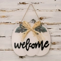 Detail of white wooden pumpkin door sign with black welcome text and rustic jute bow - Thanksgiving White Artificial Pumpkin Door Sign