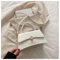 Cream PU leather handbag with gold clasp and adjustable strap on neutral background - White
