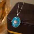 Macro detail of oval locket necklace with blue enamel and pearl on jewelry box - Oval Artificial Pearl Locket / Blue