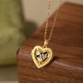 Detail showing gold heart locket with bee enamel and Mine engraving on wood - Heart Bee Locket / Black