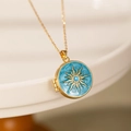Detail of vintage gold photo locket with blue enamel and sunburst engraved pattern - Round Sun Locket / Blue