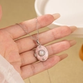 Detail of vintage oval pink locket necklace with pearl center and flower engraving - Oval Artificial Pearl Locket / Pink