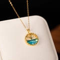 Exquisite gold fishtail necklace with blue zircon pendant on a textured jewelry box - Fish Tail Style / Gold-Blue