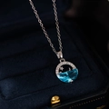Macro shot of zircon fishtail star and moon pendant necklace in a velvet jewelry box - Star Moon Style / Silver-Blue