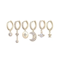 Detail of a six-piece gold celestial earring set featuring stars and moon pendants - Planet Moon Gold Set