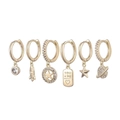 Close-up of a 6-piece gold earring set featuring celestial charms and a YOU+ME heart tag - Planet Rocket Gold Set