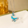 Detail of whale pendant featuring blue enamel, micro-set crystals and a white pearl accent - Steel Color Blue Dolphin Necklace