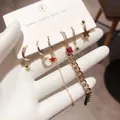 Detail of six gold earrings set featuring stars, moon charms and silver posts for women - Chain Stud Earrings 6-Piece Set - Gold