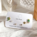 Detail of 6-piece earring set with cactus and watering can shapes on a white cloth - Potted Cactus Stud Earrings 6-Piece Set - Gold
