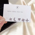 Close-up of 5-piece moon and star earring set with zircon inlays and silver posts - Star Moon Stud Earring Set