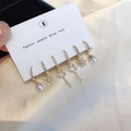 Detail of six-piece gold earring set with pearls and zircon charms on silk background - Lock Flower Pearl Earring Set Silver Color