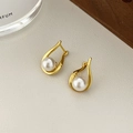 Elegant gold teardrop pearl earrings with 8mm white pearls on cream leather background - Geometric Baroque Pearl Earrings