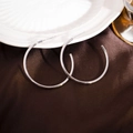 Minimalist silver C-shaped hoop earrings displayed on premium brown silk background - 40mm / Silver