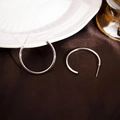 Polished silver C-shaped hoop earrings displayed on elegant silk fabric background - 30MM / Silver