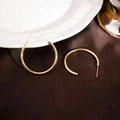 Close-up of gold C-shaped hoop earrings on a vintage ceramic plate with luxury fabric - 30MM / Gold
