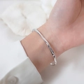 Minimalist S925 silver plated bracelet with irregular wave texture on female wrist - Wave Texture / Silver