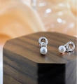 Macro view of French-style bow pearl earrings with s925 silver base and sparkling zircons - Double Ring Pearl Silver
