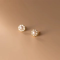 Detailed close-up of a sunflower-shaped pearl stud earring with sparkling gold plating - Round Pearl Gold