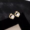 Macro shot of French luxury pearl stud earrings with gold frame and zircon detail - Hoop Earrings Gold