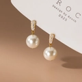 Macro shot of S925 silver bow pearl earrings with zircon and gold finish on a card - Pearl Stud-8mm Gold