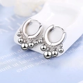 Polished silver geometric hoop earrings with decorative metal beads on a ceramic stand - Silver Bead Hoop Earrings
