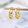 Elegant golden hoop earrings with polished small gold spheres on a minimalist display - Gold Bead Hoop Earrings