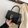 Vintage black leather crossbody bag with elegant gold metal lock and top handle strap - Black