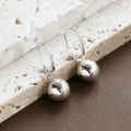Minimalist silver ball drop earrings featuring a high-polish finish on a stone background - Square Ear Buckle with Ball Pendant