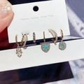 Detail view of 6-piece gold earrings set featuring Hamsa hand and colorful zircons - Palm Heart Hoop Ear Clip Set