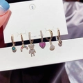 Detail of six-piece earring set featuring rainbow, bear, and heart charms on gold hoops - Bear Heart Rainbow Set