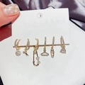 Detail of six gold-plated stud earrings with pavé zircons in fun novelty shapes - Safety Pin Scissors Earring Set