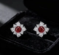 Macro shot of French vintage flower earrings with red crystal and sparkling white stones - Red Flower
